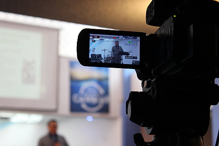 man wearing shirt filming in front of drum set in selective focus photography thumbnail