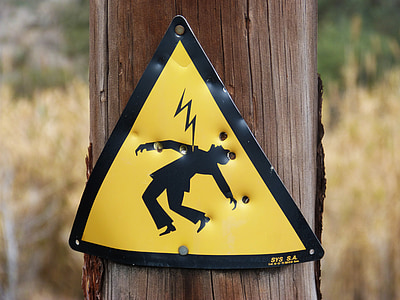 lightning hazard sign on wood post thumbnail