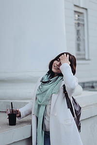 woman holding clear disposable cup thumbnail