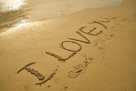 sand drawing i love you near body of water thumbnail