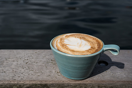 blue ceramic mug filled with coffee latte thumbnail