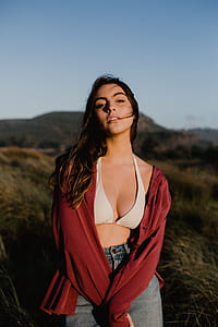 woman standing on grass field with both hand crossing each other thumbnail