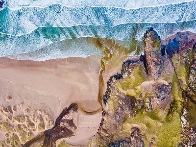 bird's eye view of seashore near cliff thumbnail