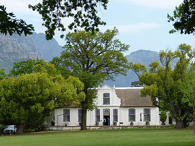 white building surrounded by trees thumbnail