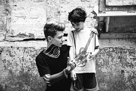 boy standing beside man while doing thumbs up thumbnail