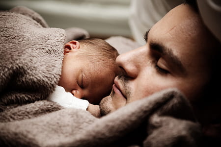 baby sleeping on man's chest thumbnail