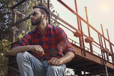 man sitting under metal bridge thumbnail