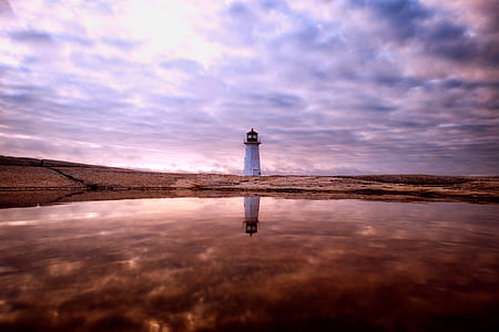 white lighthouse in the desert during daytime thumbnail