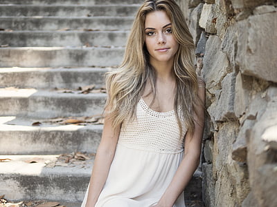 woman leaning on wall near stairs thumbnail
