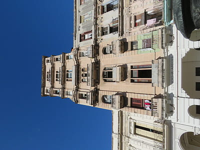 brown concrete building under blue sky thumbnail