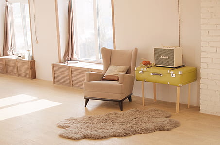 wing chair near yellow suitcase chest inside the room thumbnail