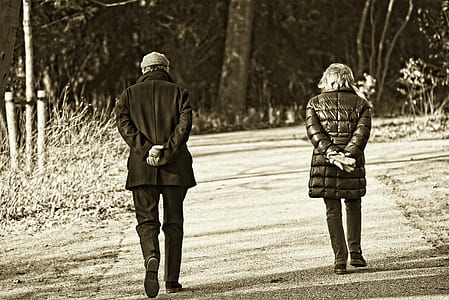grayscale photo of man and woman walking thumbnail