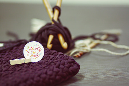 closeup photo of knitted purple pouch thumbnail