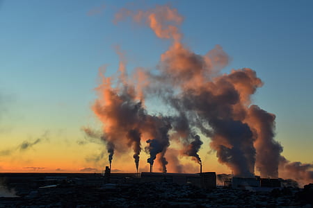silhouette photo of smoke under blue sky thumbnail