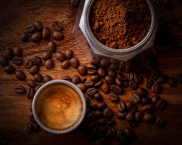 White Ceramic Mug Filled With Coffee Beside Coffee Beans thumbnail
