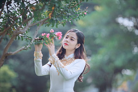 Woman Holding Pink Petaled Flower thumbnail