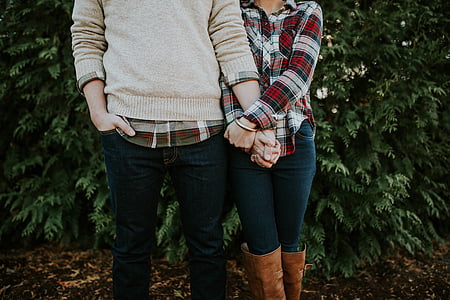 male and female standing beside trees thumbnail