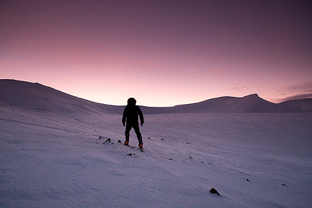 Purple Sunset in the winter of person hiking in the snow in Quebec, Canada thumbnail