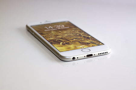 turned-on silver iPhone 6 on white surface thumbnail