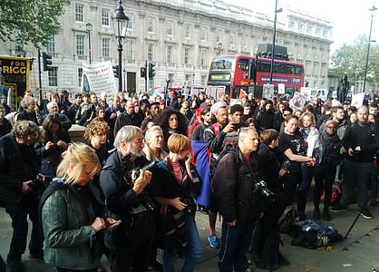 people standing near brown structure under white sky during daytime thumbnail