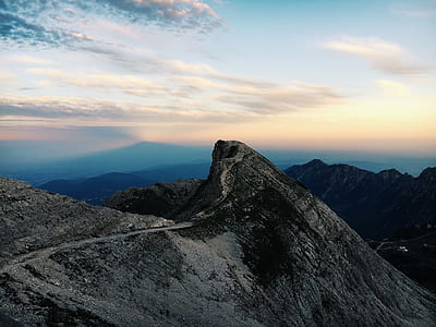 gray rock mountain under blue sky thumbnail
