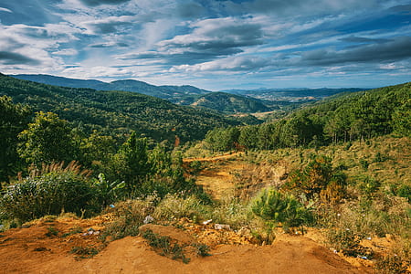 Scenic View of Mountains Under Cloudy Sky thumbnail