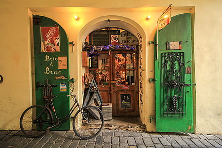 black bicycle beside wooden door thumbnail