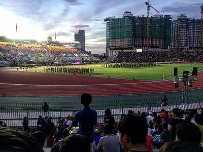 Group of People Watching Football Player Team on Field thumbnail