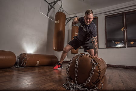 man holding brown heavy bag thumbnail