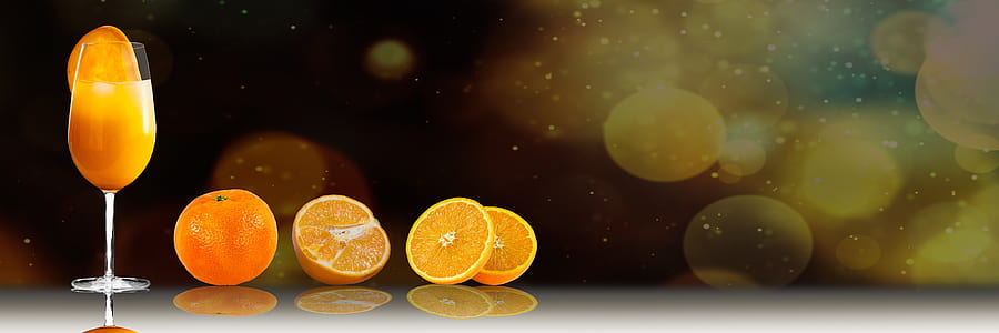 wine glass near sliced orange fruits thumbnail