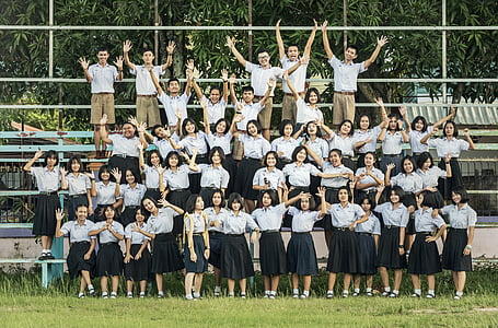 group of girls and boys standing near bleachers thumbnail