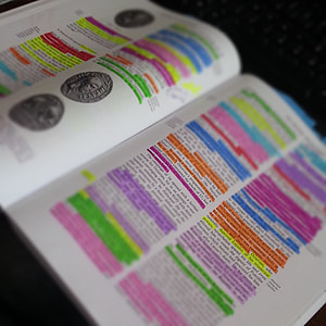 highlighted coin book on black surface thumbnail