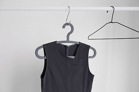 gray sleeveless shirt hanged on gray clothes hanger thumbnail