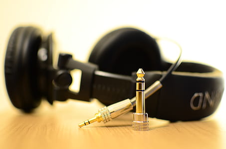 black corded stereo headphones on wooden surface thumbnail