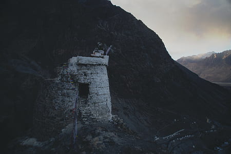 silhouette photo of concrete dungeon on mountain thumbnail