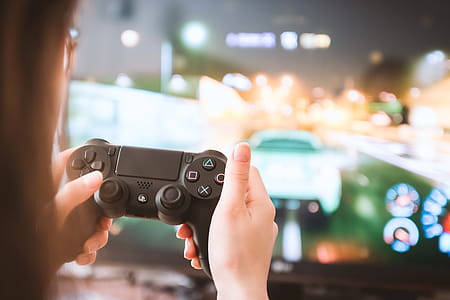 Young girl with gamepad playing games on TV thumbnail