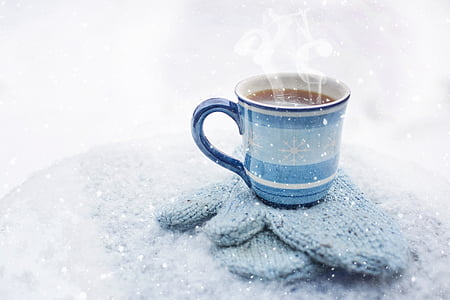 ceramic mug on knitted gloves with hot liquid thumbnail