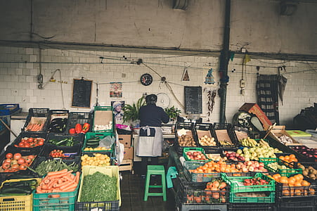 woman standing near vegetables on crates thumbnail