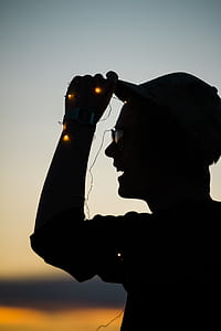 silhouette of man wearing cap with thumbnail