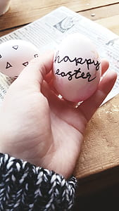 person holding white Easter egg thumbnail