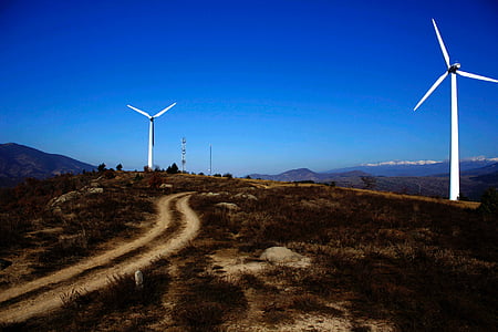 wind turbine on open field under blue sky during daytime thumbnail