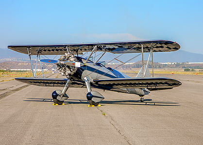 gray biplane on runway thumbnail