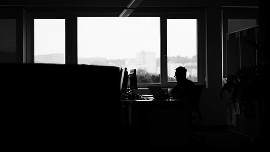 photo of man on black desk using laptop thumbnail