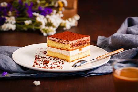 slice cake beside spoon on plate thumbnail