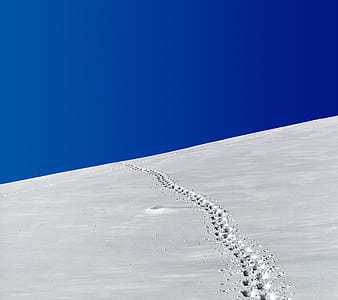 landscape photo of snow-covered hill under clear blue sky thumbnail