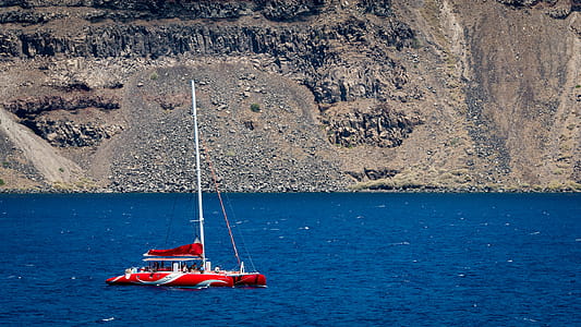Photography of Red Sailing Boat on Sea thumbnail