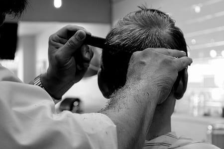 grayscale photography of barber cutting hair thumbnail