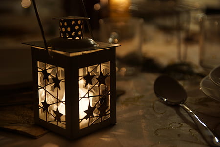black lantern with lighted candle thumbnail