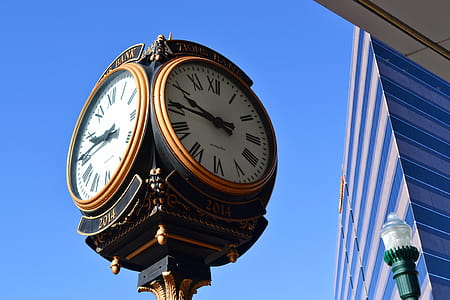 Close-up Photo of Street Clock Near Tall Building thumbnail