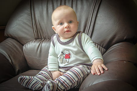 closeup photo of baby sitting on chair thumbnail